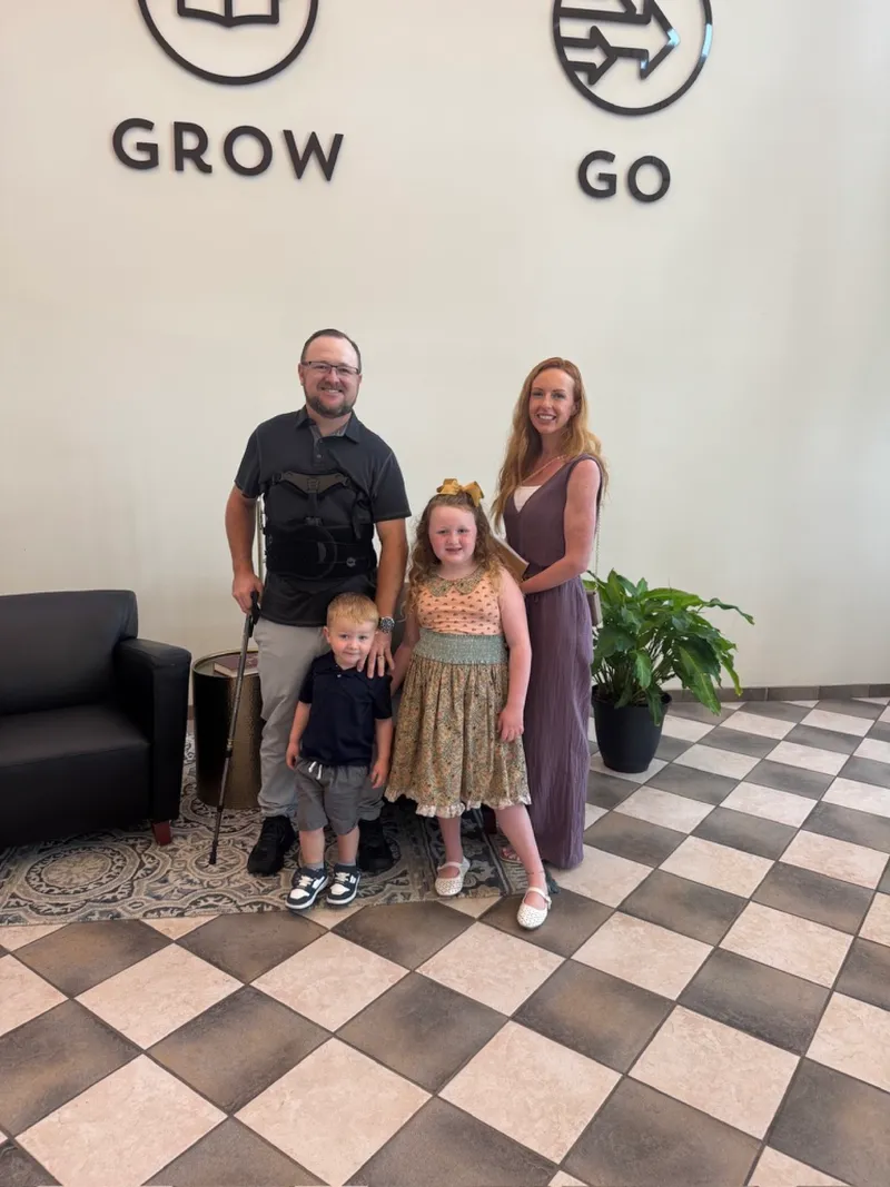 Ryan, Brittany, Kinsley and Kamden standing in a church lobby