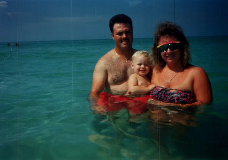 Brian, Angie and a young Ryan in the ocean at the beach