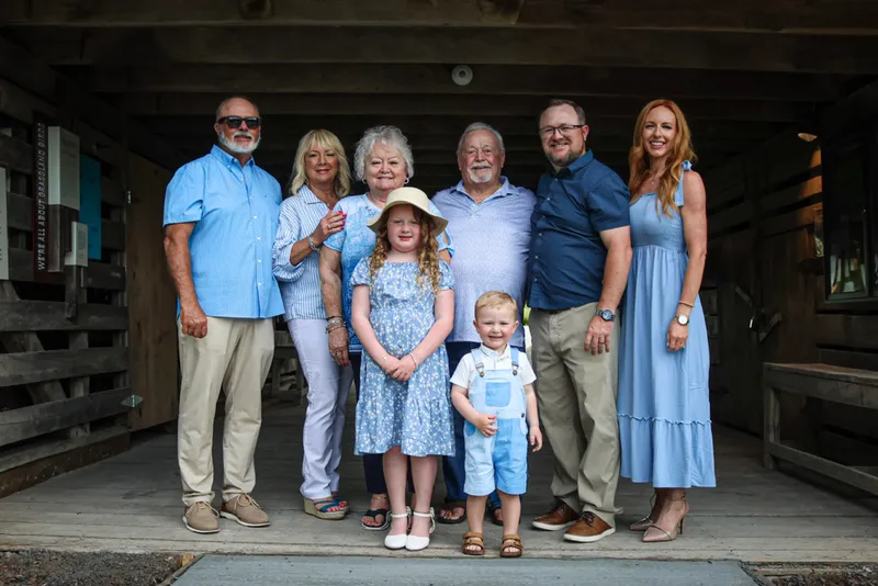 Three generations of the King family together under a wooden pavilion